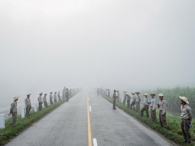Daily Life - First Prize, Stories © Tomas Munita, for The New York Times Title: Cuba On The Edge Of Change Members of the Ejercito Juvenil del Trabajo wait along the road to Santiago de Cuba at dawn for Fidel Castro’s caravan. Cuba declared nine days of mourning after Fidel Castro’s death, a period that culminated with his funeral. In December, days after Fidel Castro’s death, his ashes were taken into the countryside, on a route that retraced, in reverse, the steps of the revolution he led in 1959. Towns and villages along the route were emptied of residents as thousands tried to catch a glimpse of Castro’s remains.