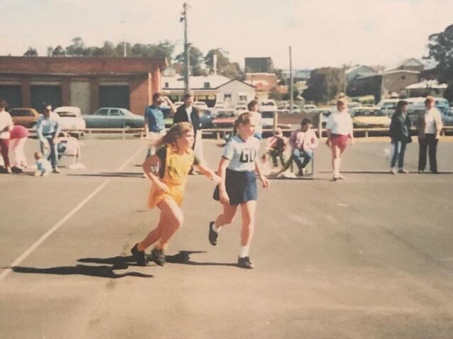 Emma McBride (wearing blue) playing netball at Baker Park as a child.