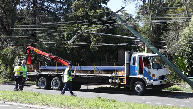 The truck ran up the gutter and snapped the power pole. Picture: John Grainger