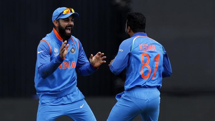 Catcher, India's Virat Kohli (L) celebrates with bowler India's Kedar Jadhav (R) after they combine to take the wicket of Bangladesh batsman Mushfiqur Rahim during the ICC Champions Trophy semi-final cricket match between India and Bangladesh at Edgbaston in Birmingham on June 15, 2017. Bangladesh made 264 for seven against title-holders India in their Champions Trophy semi-final after being sent into bat at Edgbaston on Thursday. / AFP PHOTO / Adrian DENNIS / RESTRICTED TO EDITORIAL USE