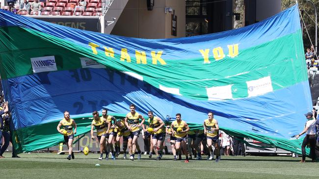 The Eagles run out at the start of the SANFL grand final, led by their captain Luke Thompson. Picture: Sarah Reed