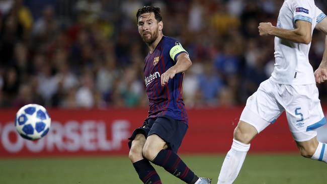 Barcelona forward Lionel Messi slots home his third goal for Barcelona against PSV Eindhoven. Picture: AP