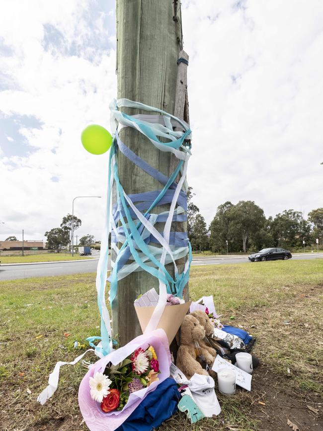 A memorial for two teenagers who crashed into a power pole on the intersection of Cowpasture Road and the Horsley Drive while driving a stolen car. Picture: Monique Harmer