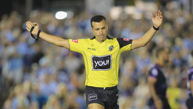 Referee Matt Cecchin awards a penalty.