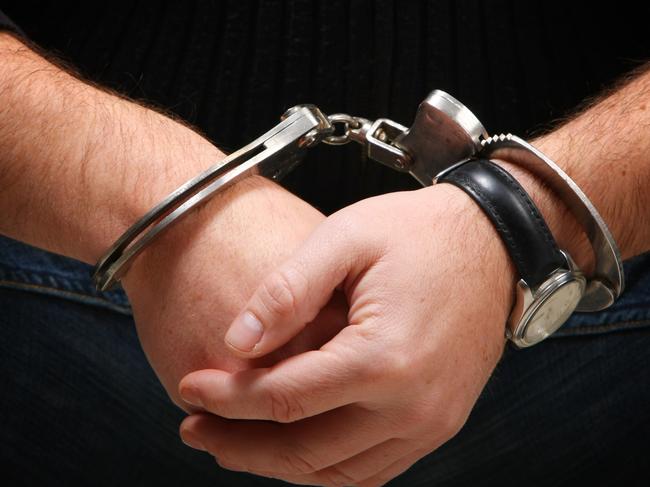 Busted - Man wearing handcuffs Source : Thinkstock