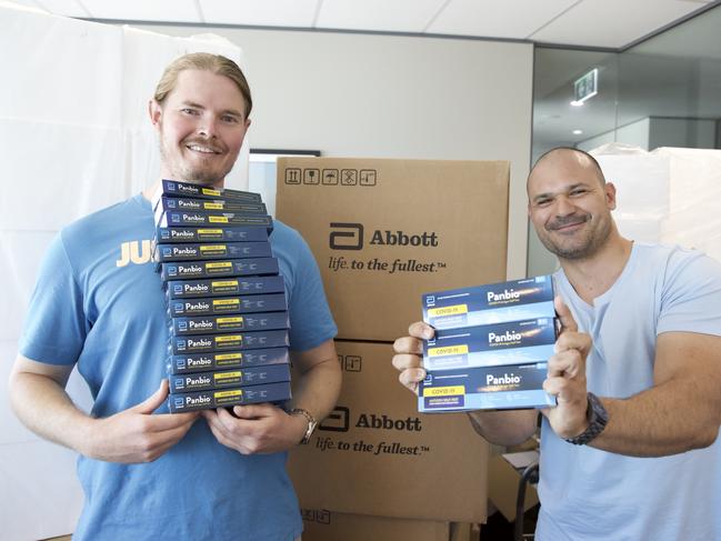 STELPH Medical director Samuel Ward and marketing science manager Adam Troyn holding highly sought after RATs. Picture: Floss Adams.