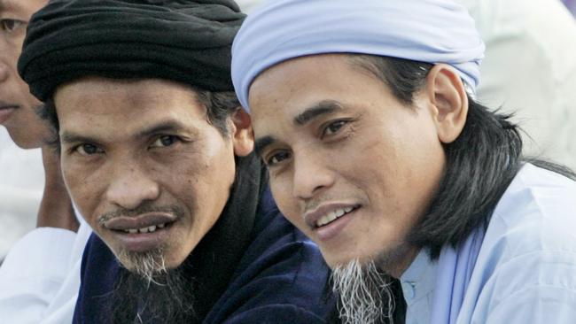 Convicted Bali bombers Amrozi Nurhasyim, right, and Ali Ghufron, who are currently on death row, are seen before the start of Eid al-Fitr prayer marking the end of the holy fasting month of Ramadan at Batu prison on Nusakambangan island, Indonesia, Oct. 1, 2008. (AP Photo/Dita Alangkara)