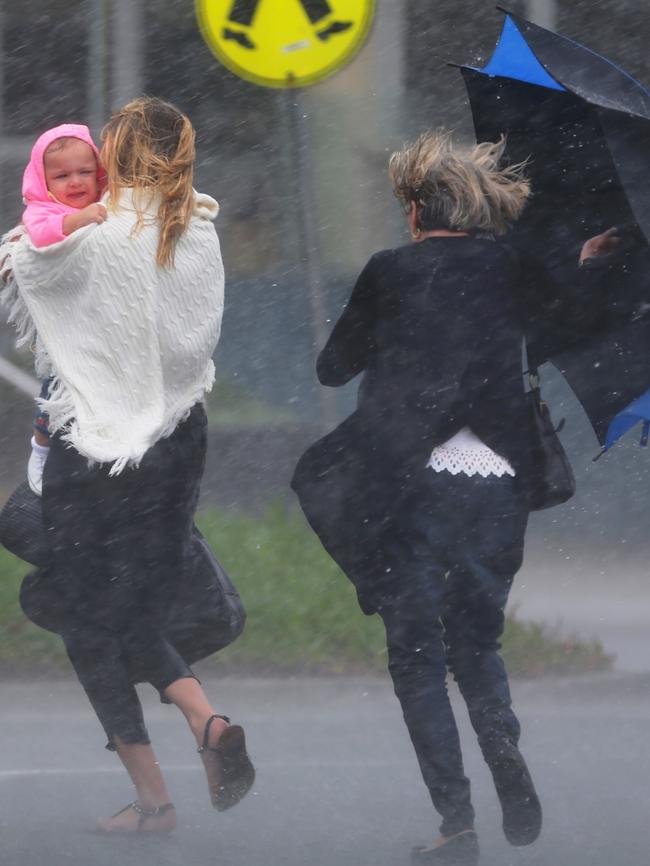 People were caught in the rain at Bondi Beach on Monday. Picture: John Grainger.