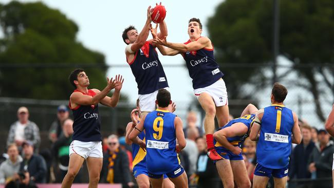 Jordan Moncrieff, flying for a mark with Cam Pedersen (left) at Casey Demons, is a key recruit for Mt Eliza.