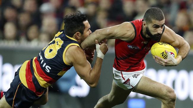 Eddie Betts tries to latch on to Essendon speed machine Adam Saad on Friday night. Picture SARAH REED