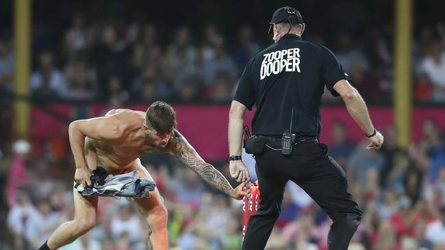 Chad Sharp removes a stump as he invades the pitch during the Big Bash League match between the Sydney Sixers and the Sydney Thunder at Sydney Cricket Ground on Saturday. Picture: Mark Kolbe/Getty Images