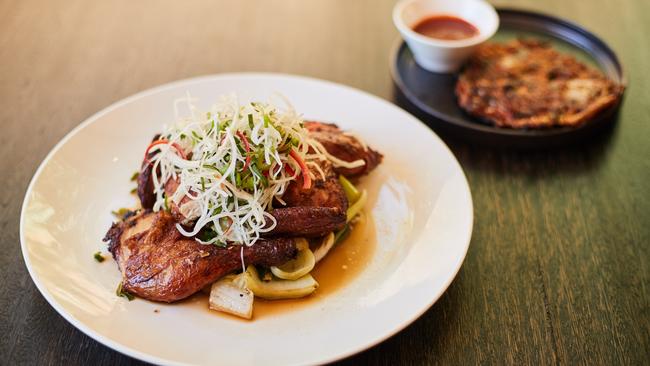 Korean style crispy skin spatchcock on black vinegar cabbage with kimchi pancake at Henry's in Adelaide. Picture: Matt Loxton