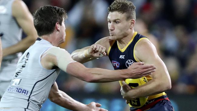 Adelaide ball magnet Rory Laird brushes Carlton’s Paddy Dow aside on his way to 32 disposals at Adelaide Oval last week. Picture: Sarah Reed.