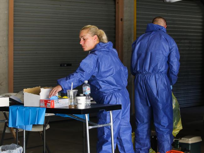 Forensic officers at the unit block in Wyong where the body of a man was located and a woman was allegedly kidnapped. Picture: Newscorp / Gaye Gerard