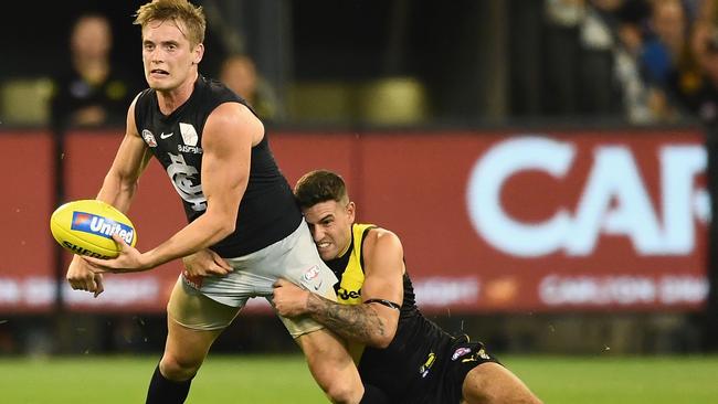 Jack Graham illustrates his desperation and tackling prowess by hauling down Carlton’s Ciaran Byrne during Richmond’s round one triumph at the MCG. Picture: Quinn Rooney (Getty Images).