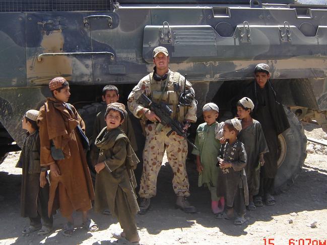 Voodoo Medic Brad Watts pictured with local children in Afghanistan.