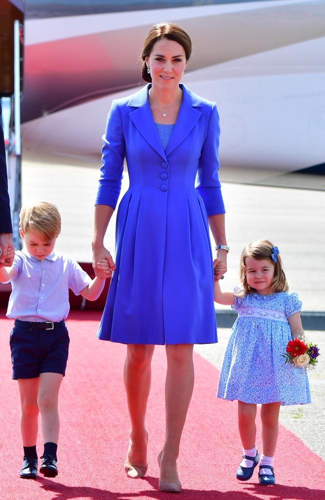 Seeing triple? The Duchess of Cambridge, alone with Prince George and Princess Charlotte, all wore blue at Berlin Tegel Airport. Picture: Getty Images