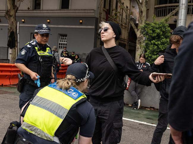 Members of Victoria Police search pro-trans activists. Picture: NewsWire / Diego Fedele