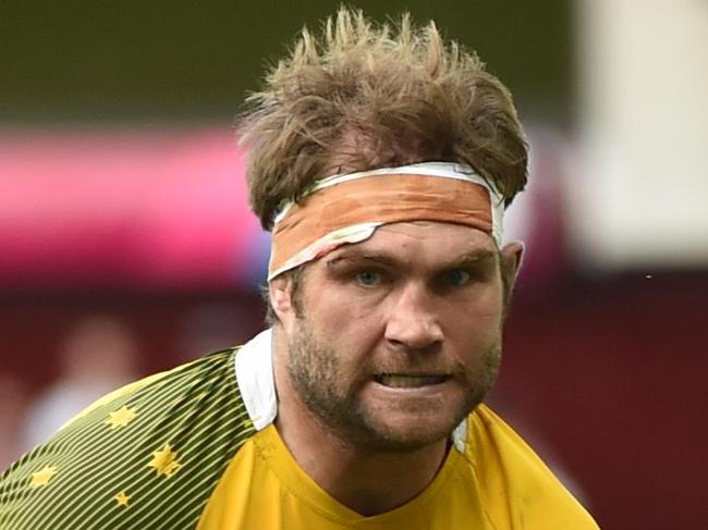 Australia's flanker Ben McCalman runs in to score his second try, Australia's eighth, during the Pool A match of the 2015 Rugby World Cup between Australia and Uruguay at Villa Park in Birmingham, north England on September 27, 2015. AFP PHOTO / BERTRAND LANGLOIS RESTRICTED TO EDITORIAL USE, NO USE IN LIVE MATCH TRACKING SERVICES, TO BE USED AS NON-SEQUENTIAL STILLS