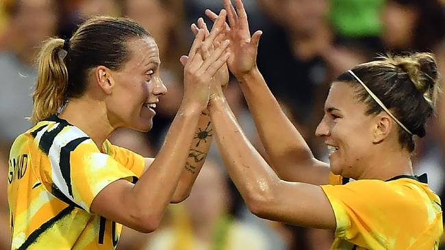 Emily van Egmond (L) celebrates with teammates Stephanie Catley. Picture: Saeed Khan/AFP