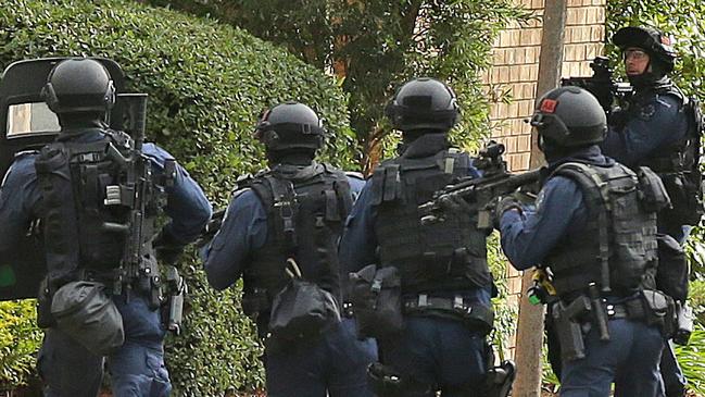 East Terrace Siege. Star Group officers rush in just after shots are heard. Picture Dylan Coker