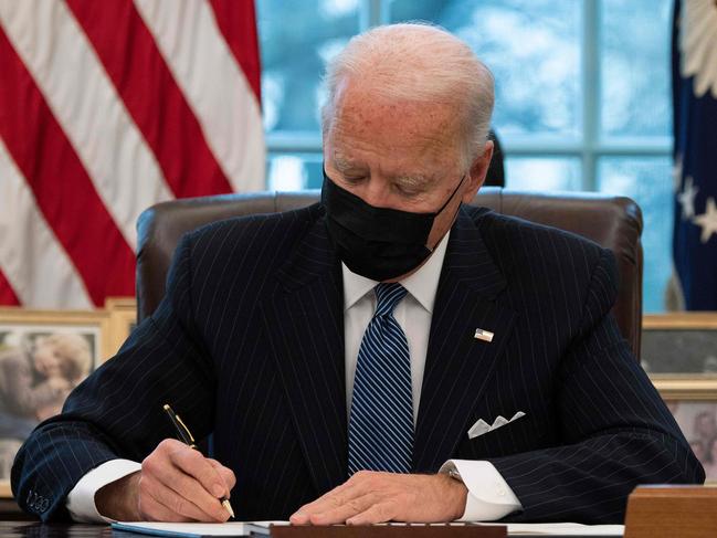 US President Joe Biden signs an Executive Order reversing  Trump era ban on Transgender serving in the military while in the Oval Office of the White House in Washington, DC, on January 25, 2021. (Photo by JIM WATSON / AFP)