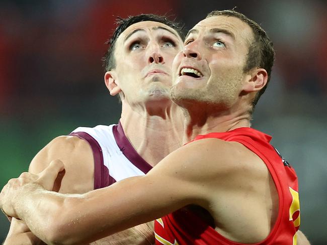 GOLD COAST, AUSTRALIA - APRIL 24: Oscar McInerney of the Lions and Jarrod Witts of the Suns compete for the ball the round six AFL match between the Gold Coast Suns and the Brisbane Lions at Metricon Stadium on April 24, 2022 in Gold Coast, Australia. (Photo by Chris Hyde/Getty Images)