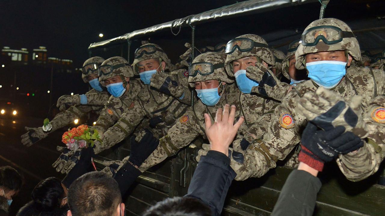 The North Koreans do love a military parade, but now face masks have been added to the uniform to protect against the threat of COVID-19. Picture: AFP PHOTO/KCNA VIA KNS