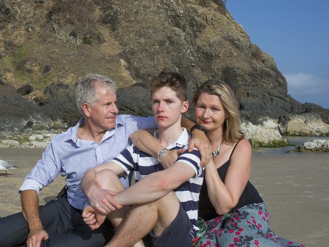 THEAUSTRALIAN- Photo in reference to The Lighthouse podcast. Photo shows Connor Meldrum (middle) with Father David Meldrum and Mother Kim Goodrick at Cosy Corner Tallows Beach Byron Bay.  Connor fell from the cliff face at Cape Byron during a climbing accident earlier this year shattering his skull which left him with severe brain injuries. 28th Nov 2019 Photo by  Natalie Grono