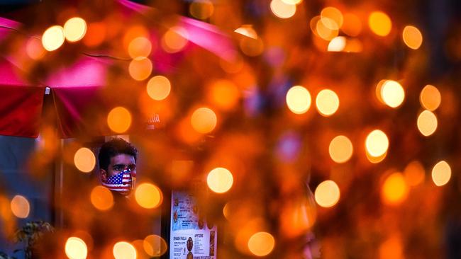 A waiter wears a face mask outside a restaurant at a shopping centre in Miami Beach, Florida, this week. Picture: AFP