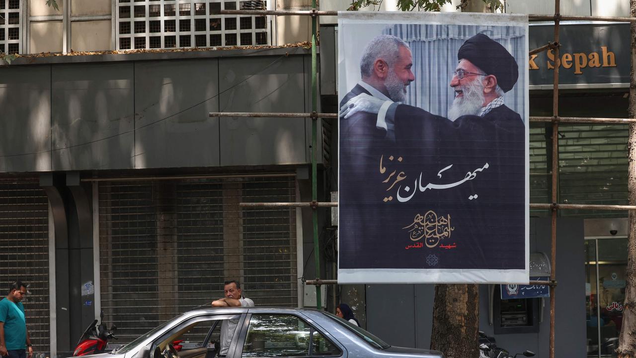 A poster of Iranian supreme leader Ayatollah Ali Khamenei (R) and slain Hamas leader Ismail Haniyeh in Tehran. Picture: Ayya Kenare/AFP