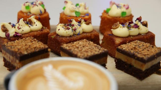 The killer bee flat white coffee with a selection of treats. Photo: Martin Lange.