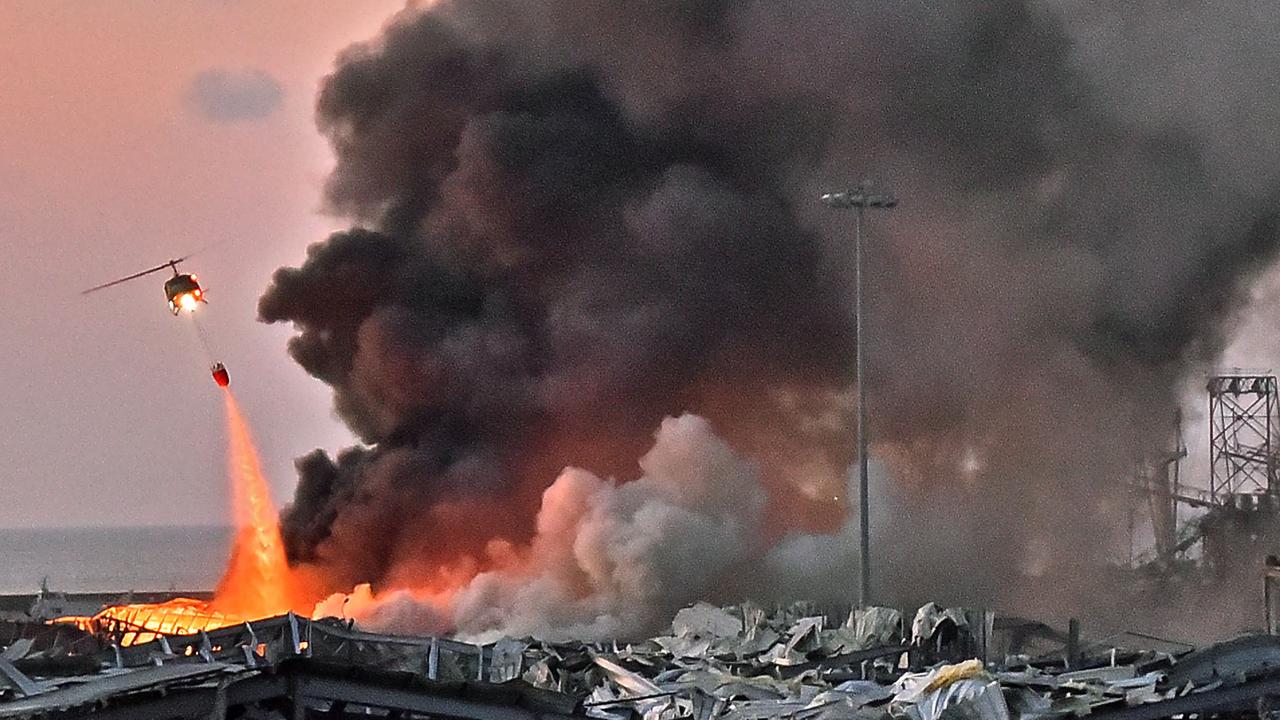 A helicopter puts out a fire at the scene of an explosion at the port of Lebanon's capital Beirut. Picture: STR / AFP