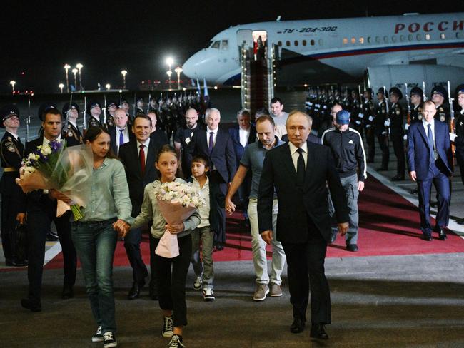 In this photograph distributed by Russian state agency Sputnik, Russia's President Vladimir Putin welcomes Russian citizens released in a major prisoner swap with the West, at Moscow's Vnukovo airport. Picture: AFP