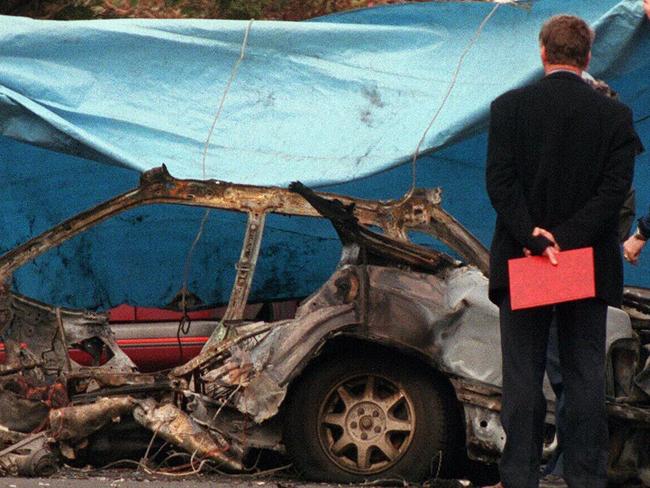 Police examine remains of Subaru Liberty destroyed by massive blast, believed to be caused by bomb, killing driver John Furlan (48) in North Coburg, 03/08/98.Victoria / Bombing / Motor Vehicle / Car