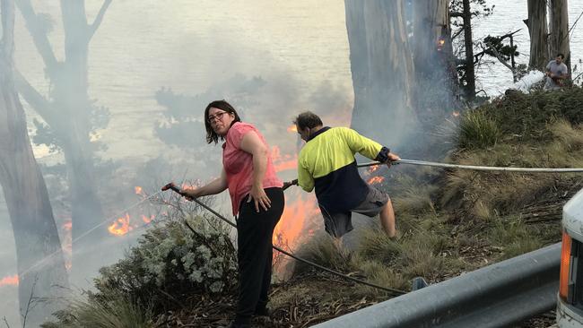 Firefighters and residents control a burn at Coal Point on Bruny Island. Picture: EDDIE SAFARIK