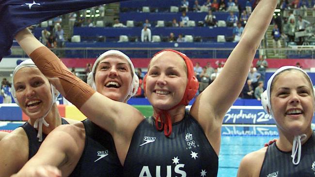 Aust water polo player goalkeeper Liz Weekes (red cap) with teammates after winning Australia vs USA women's final match at Sydney Olympic Games 23 Sep 2000. flag