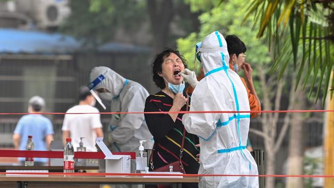 \A medical worker takes a swab sample from a woman to be tested for COVID-19 in a neighnorhood in Wuhan, in China’s central Hubei province on May 15.