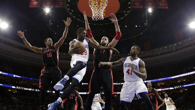 Philadelphia 76ers' Jerami Grant (39) tries to pass the ball to Thomas Robinson (41) as Toronto Raptors' DeMar DeRozan (10) and Jonas Valanciunas (17) defend.