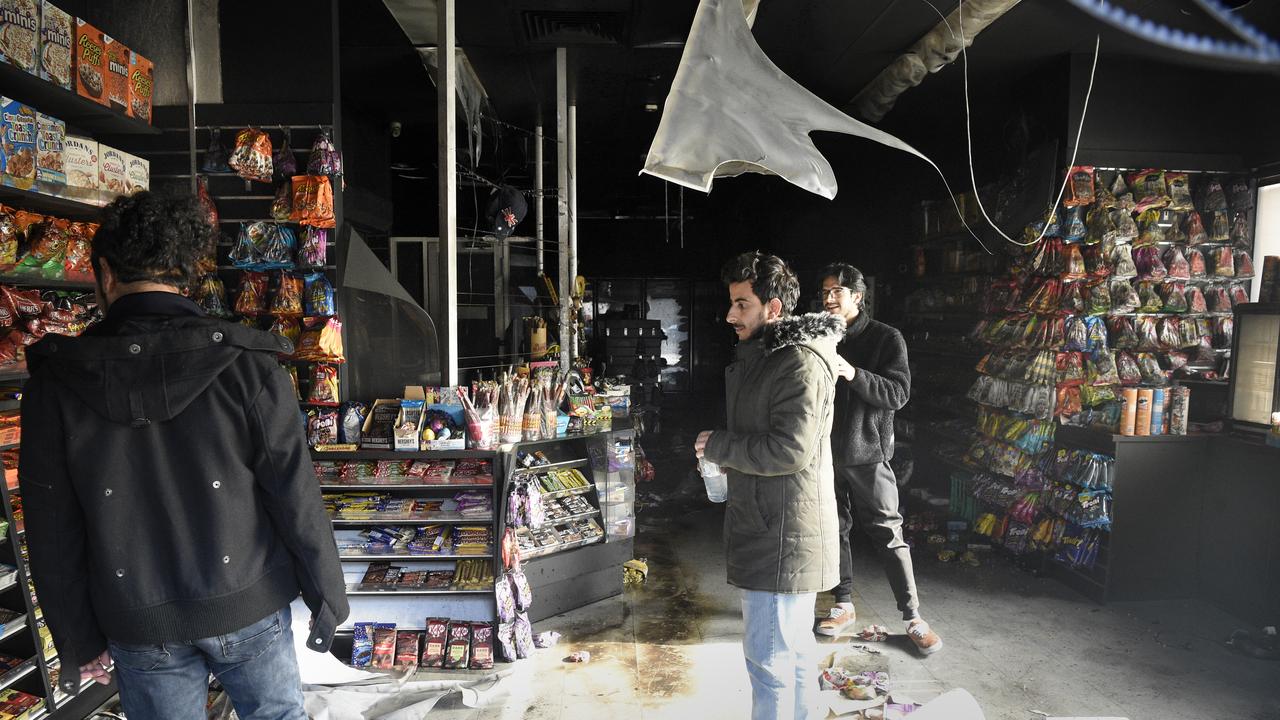 Staff inspect the fire damaged interior of Harry Mart on Chapel Street Prahran after an early morning arson attack. Picture: NCA NewsWire / Andrew Henshaw