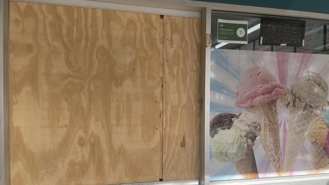 Wooden sheets barricade the glass windows at the front of Sundaes @ The Pier after recent break-ins.