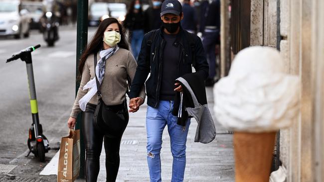 A young couple go shopping in Rome. Picture: AFP