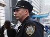 NEW YORK, NY - JULY 20: An NYPD officer keeps watch in front of an AMC move theater where the film 'The Dark Knight Rises' is...