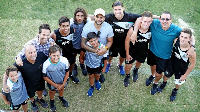 Port Adelaide's father/son academy training participants, from left to right, George Fiacchi with son Zane, Gavin Wanganeen and son Tex, Peter Burgoyne with sons Trent, Jase and Rome, academy director Stuart Cochrane, and Darren Mead with sons Jackson and Mitch earlier this year. Picture: Dylan Coker