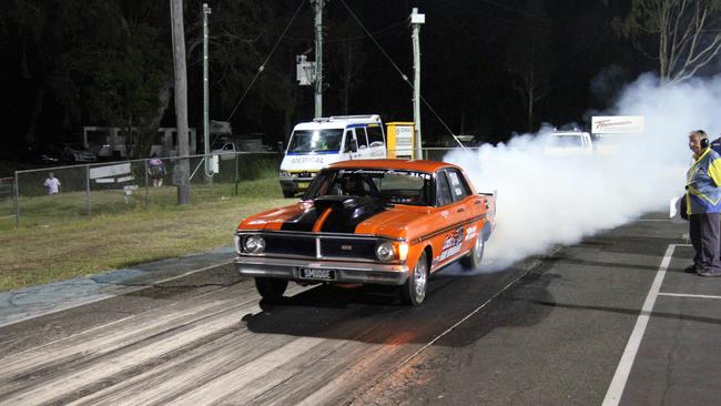 Noel 'Smudge' Smith does a strong burnout in his genuine GT Falcon drag car at Benaraby dragway. Picture: Rodney Stevens