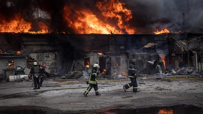 Firefighters work to extinguish a fire at a warehouse after it was hit by Russian shelling in Kharkiv, Ukraine. Picture: Getty Images