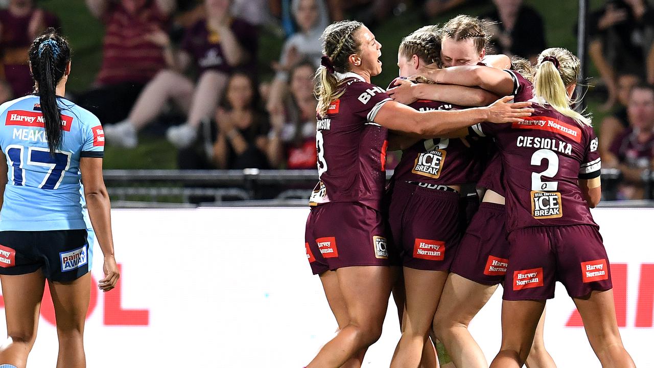 Maroons players celebrate a try during the win.