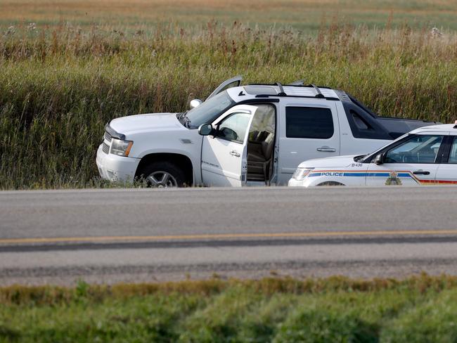 Canadian Police vehicles are seen next to the vehicle at the scene where suspect Myles Sanderson was arrested, along Highway 11 in Weldon, Saskatchewan, Canada. Picture: Lars Hagberg / AFP