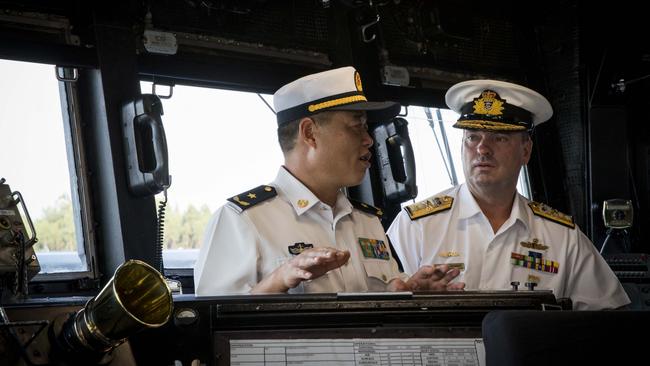 RAN fleet commander, Rear Admiral Jonathan Mead, right, with PLA-N South China chief of staff, Rear Admiral Wang Zaijie, on the Melbourne’s bridge in Zhanjiang. Picture: ADF