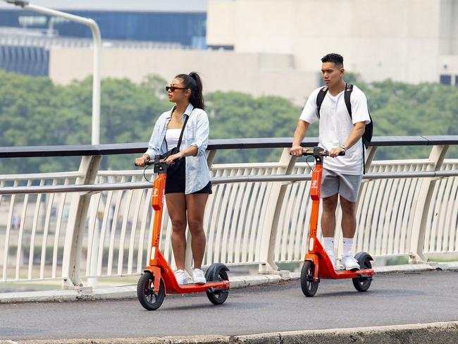 People riding Neuron e-scooters through Brisbane. Picture: Richard Walker